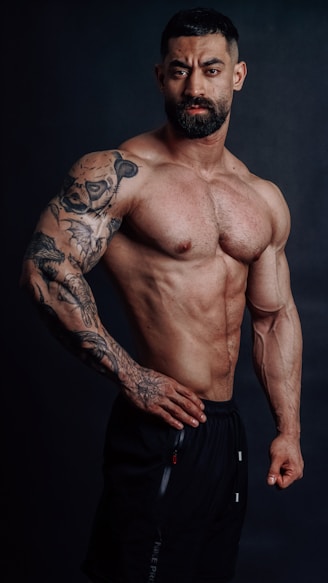 Muscular man posing, showing off his physique.