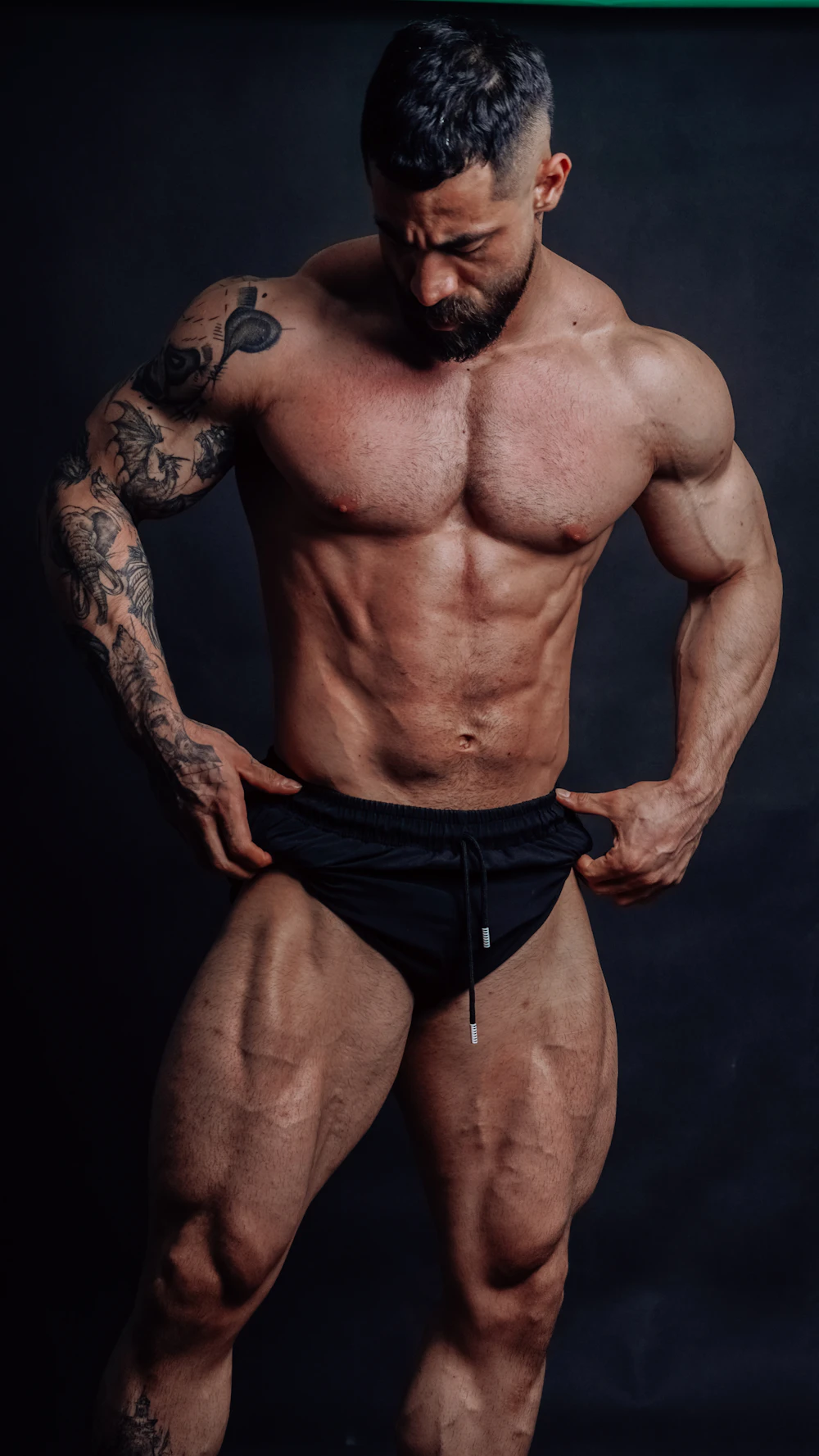 Muscular bodybuilder posing under dramatic light