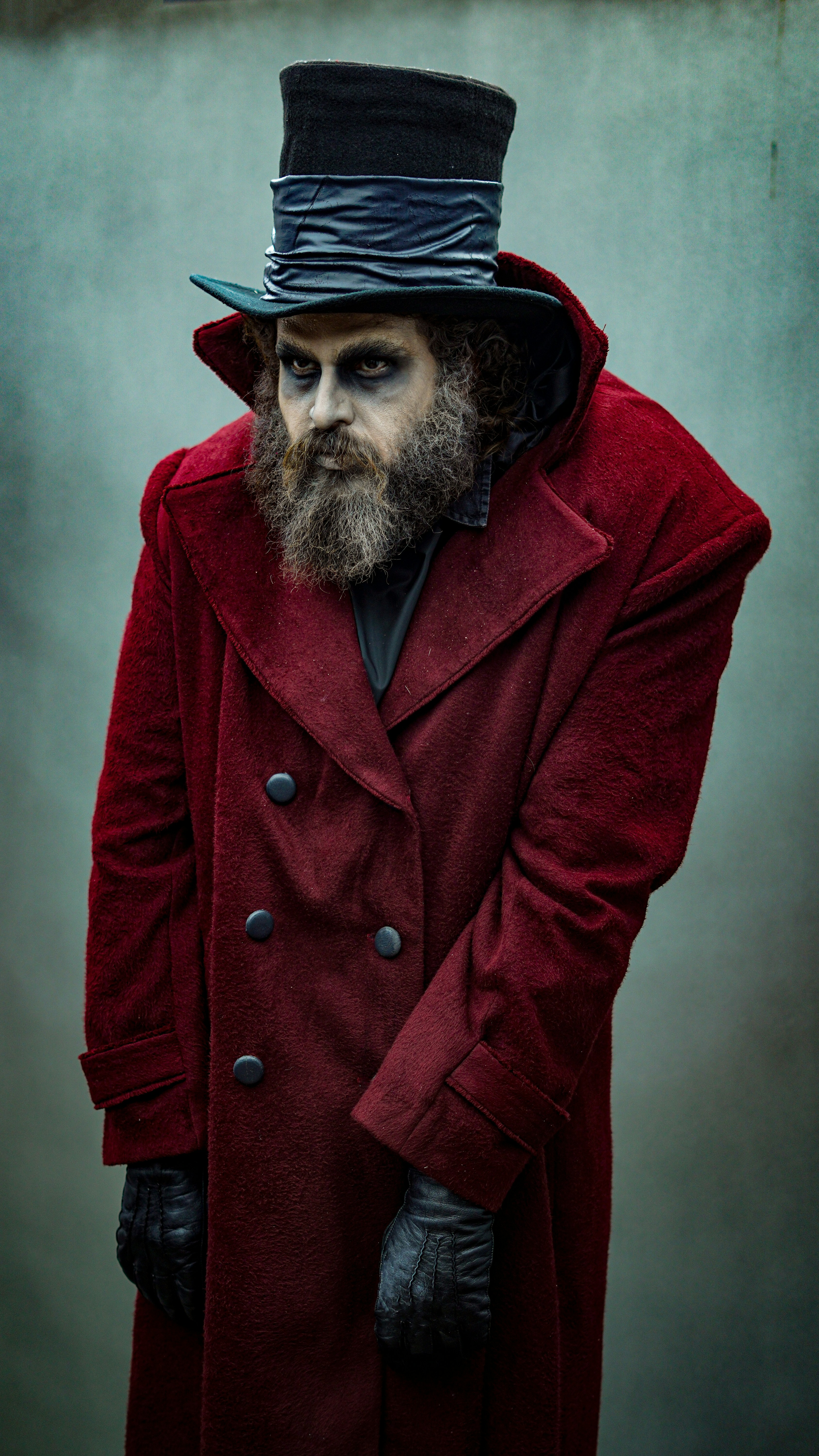 A creepy man in a hat and coat.