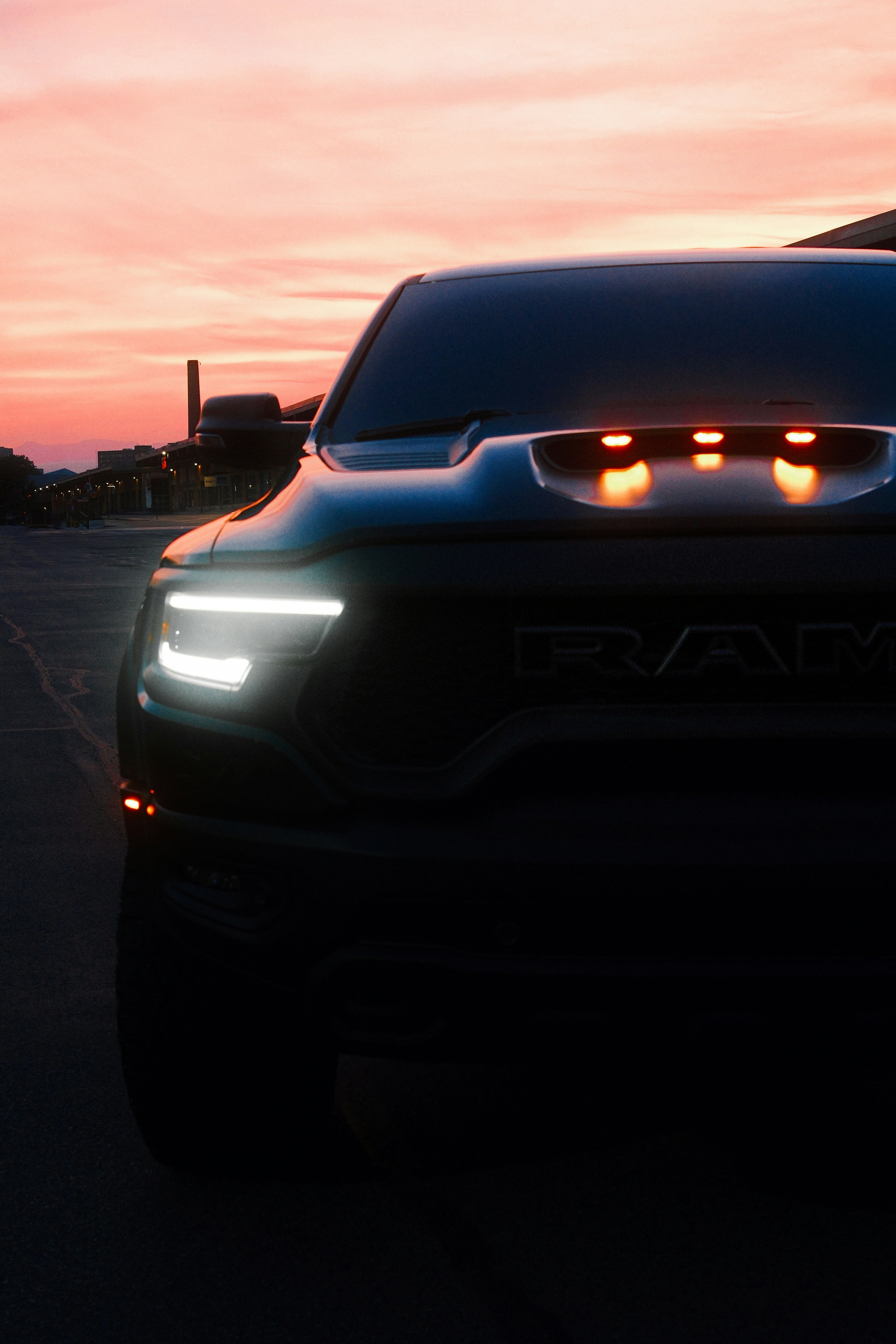 A ram truck is silhouetted by a sunset.