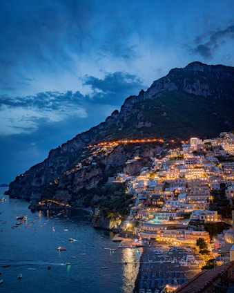 Coastal town lights up at dusk.
