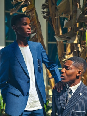 Two men in suits pose for a photo.