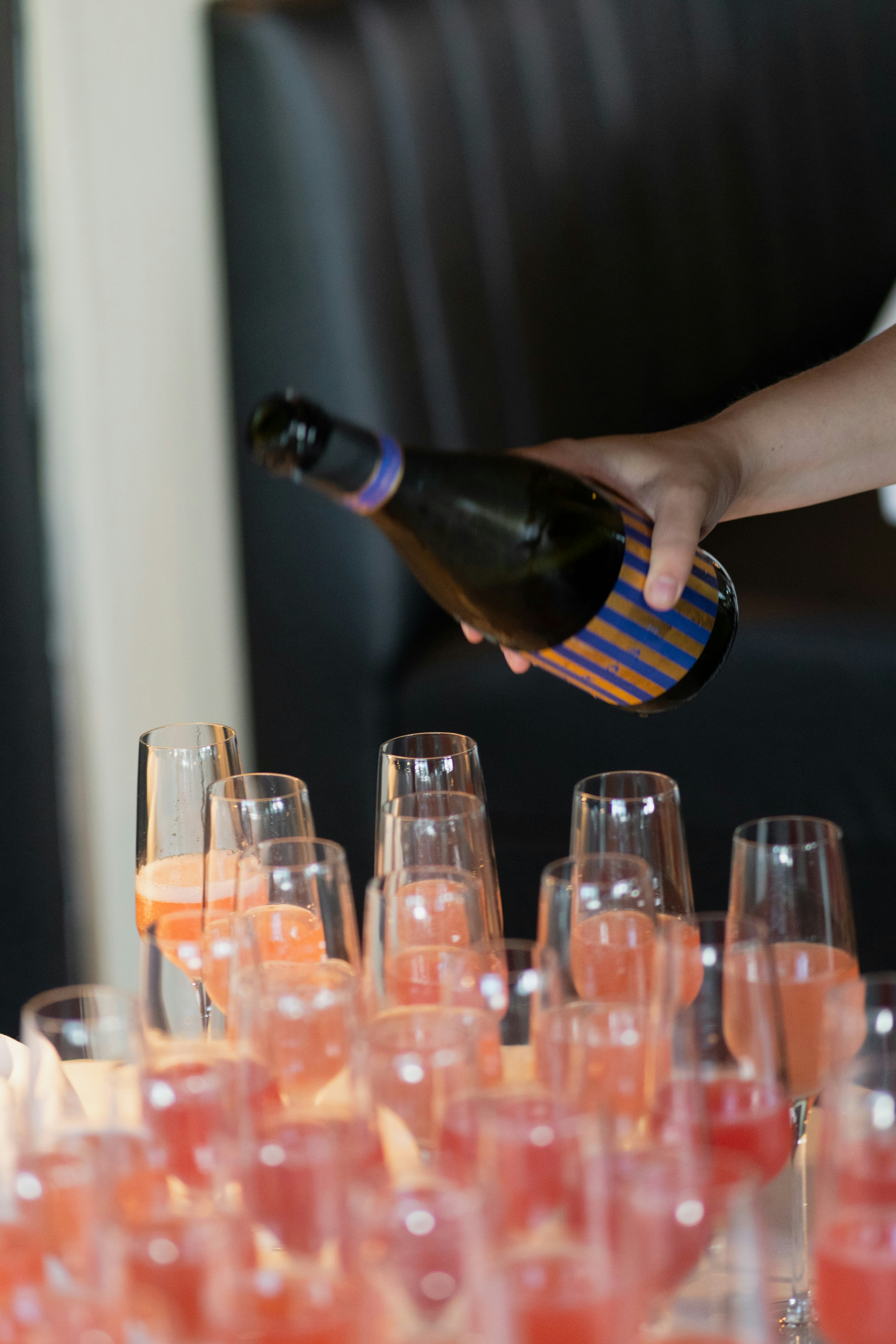 Someone is pouring champagne into glasses.