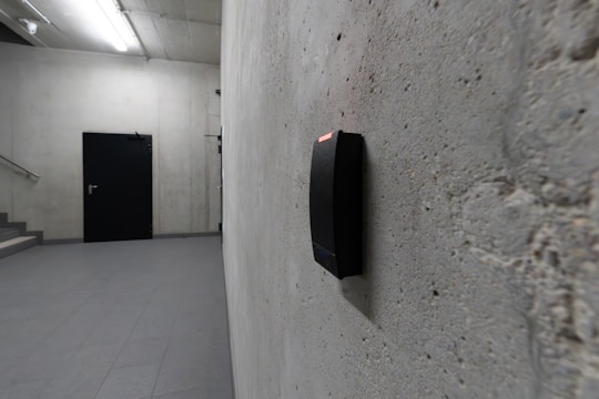 A card reader and a dark door are visible.
