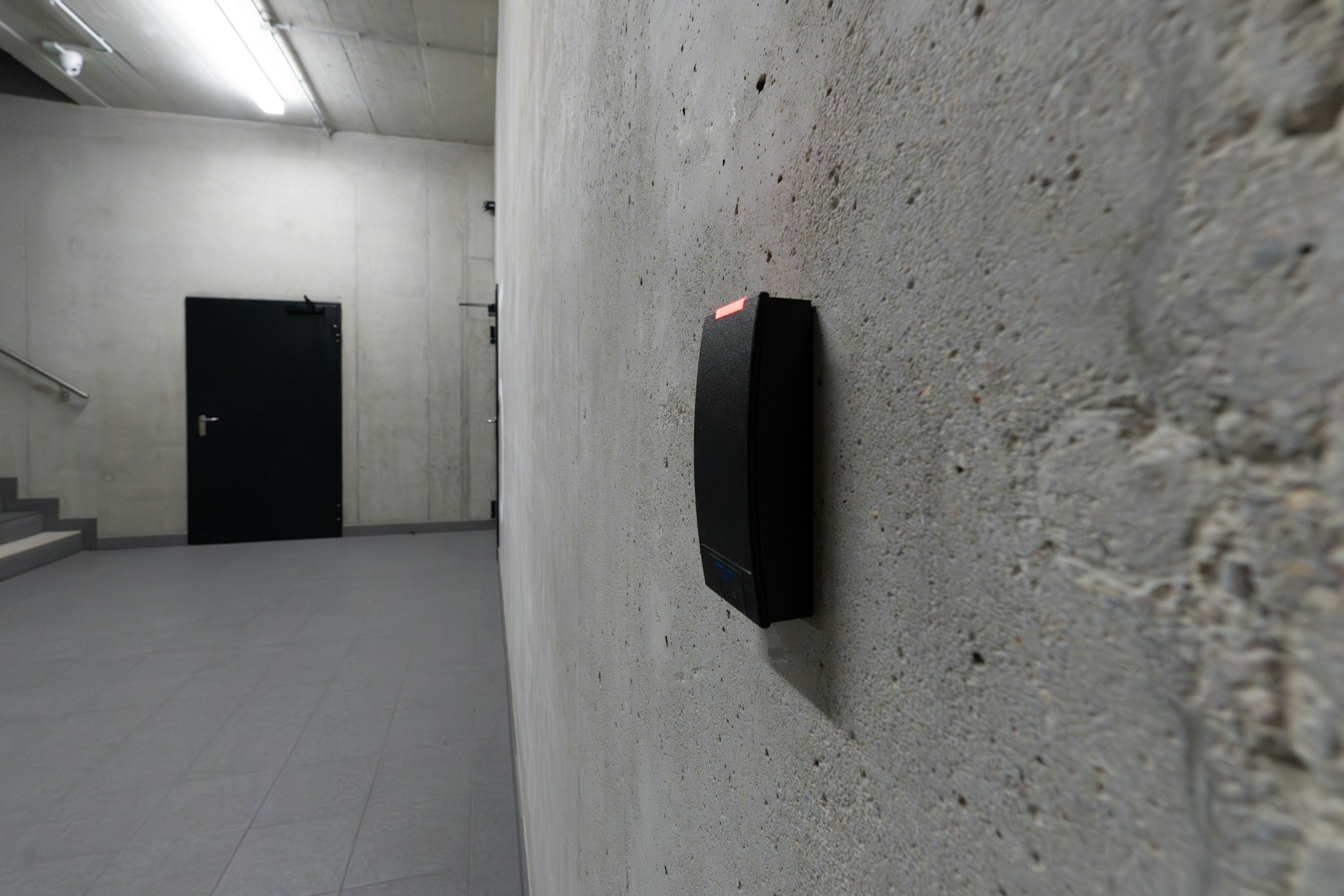A card reader and a dark door are visible.