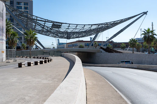 A modern roadway under a suspended structure.