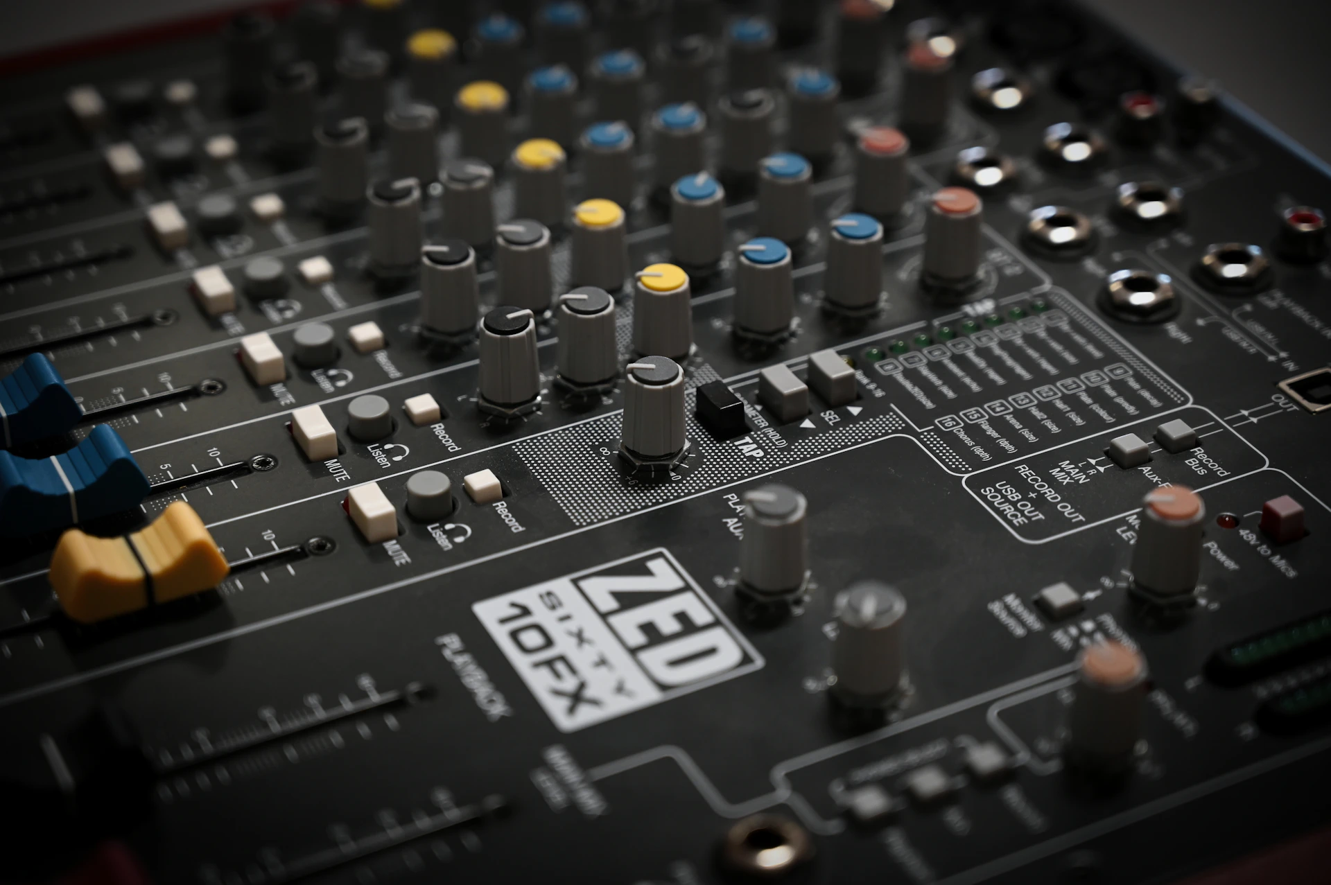 A close-up shot of a sound mixing board.