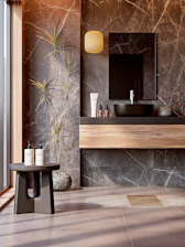 Elegant bathroom with marble walls and natural elements.