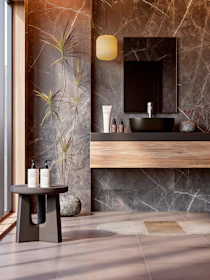 Elegant bathroom with marble walls and natural elements.