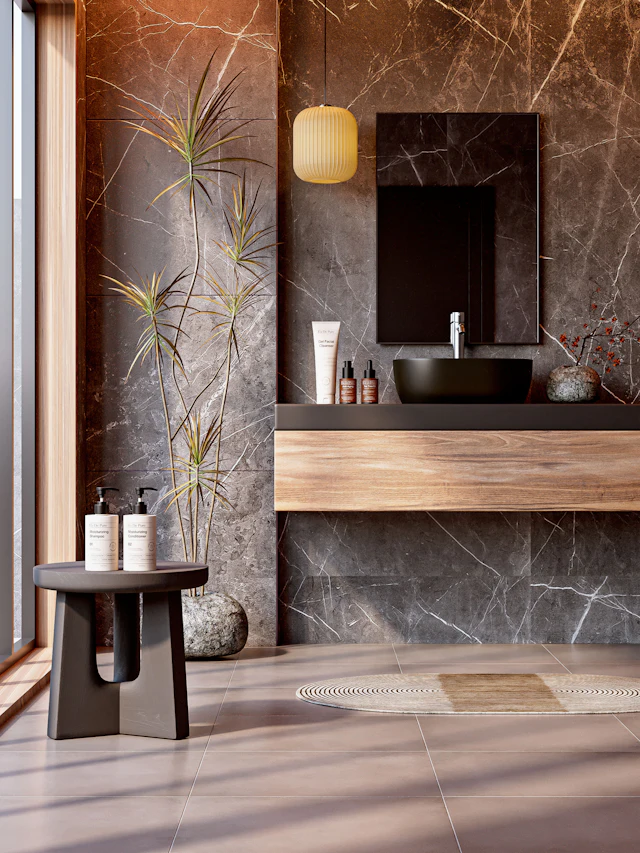 Bathroom with brown and grey marble walls, a stool and dried grass