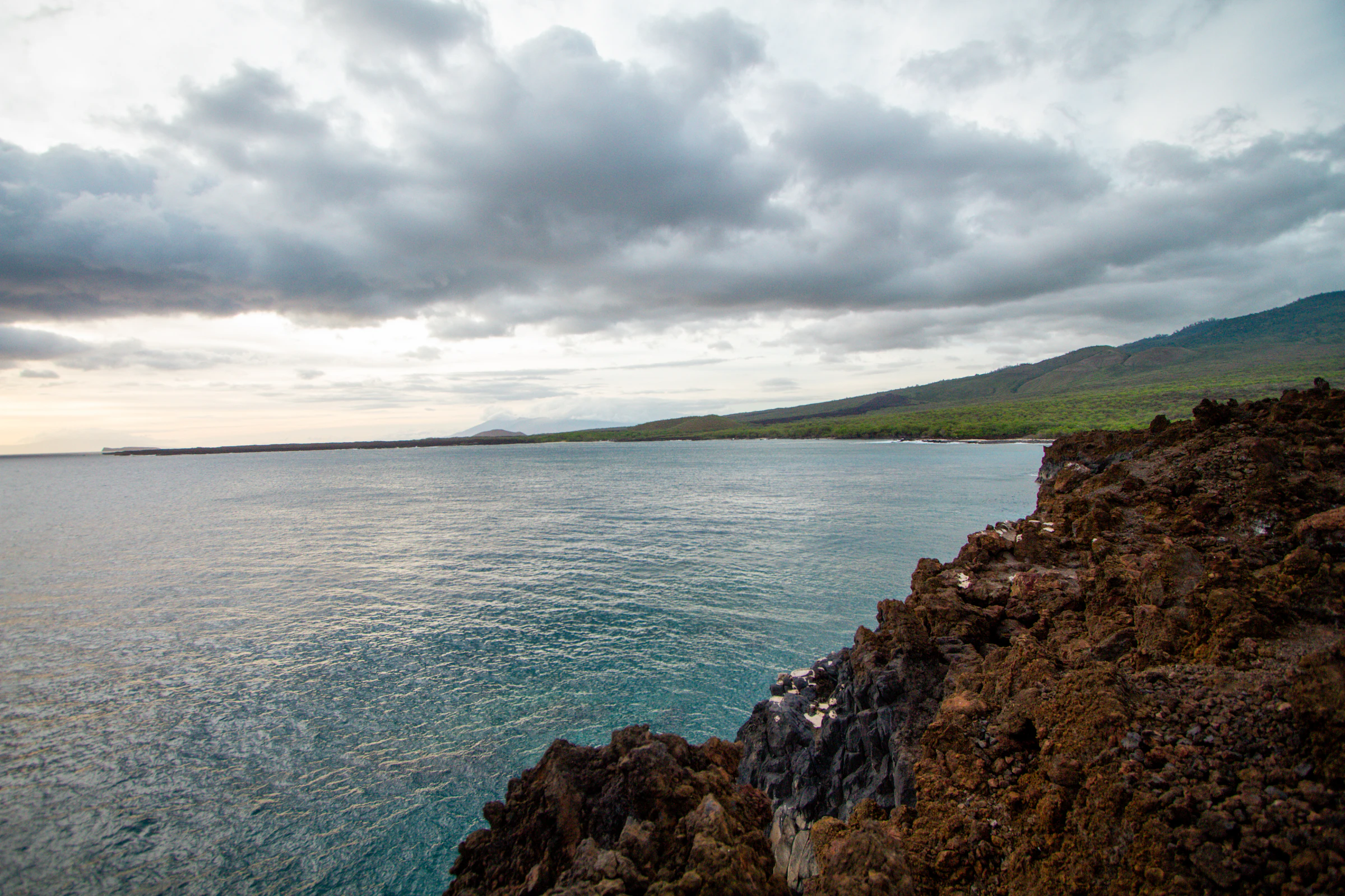 Rocky Maui coastline and Pacific Ocean under a cloudy sky
