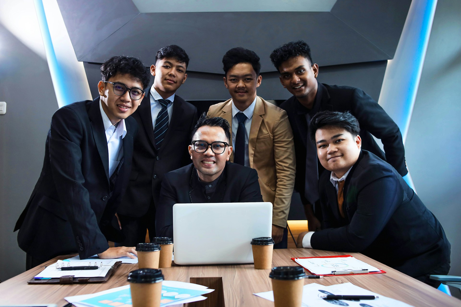 A team of professionals is gathered around a table.