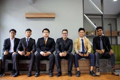 A group of men in suits are posing.