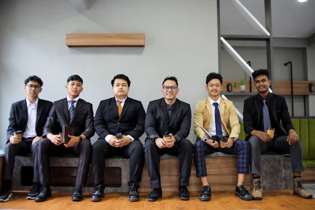 A group of men in suits are posing