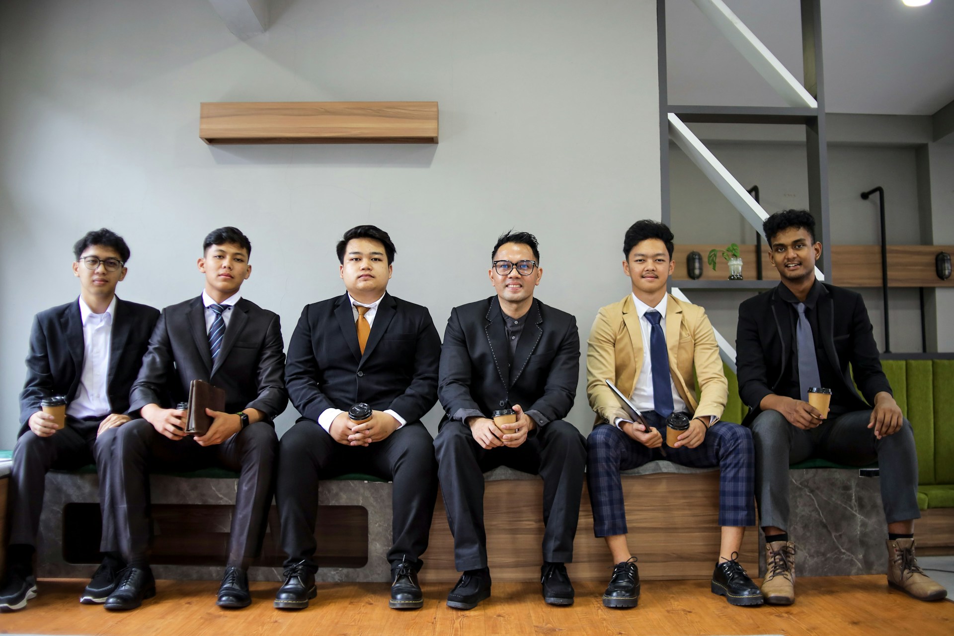 A group of men in suits are posing.