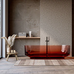 A modern bathroom with a red tub.
