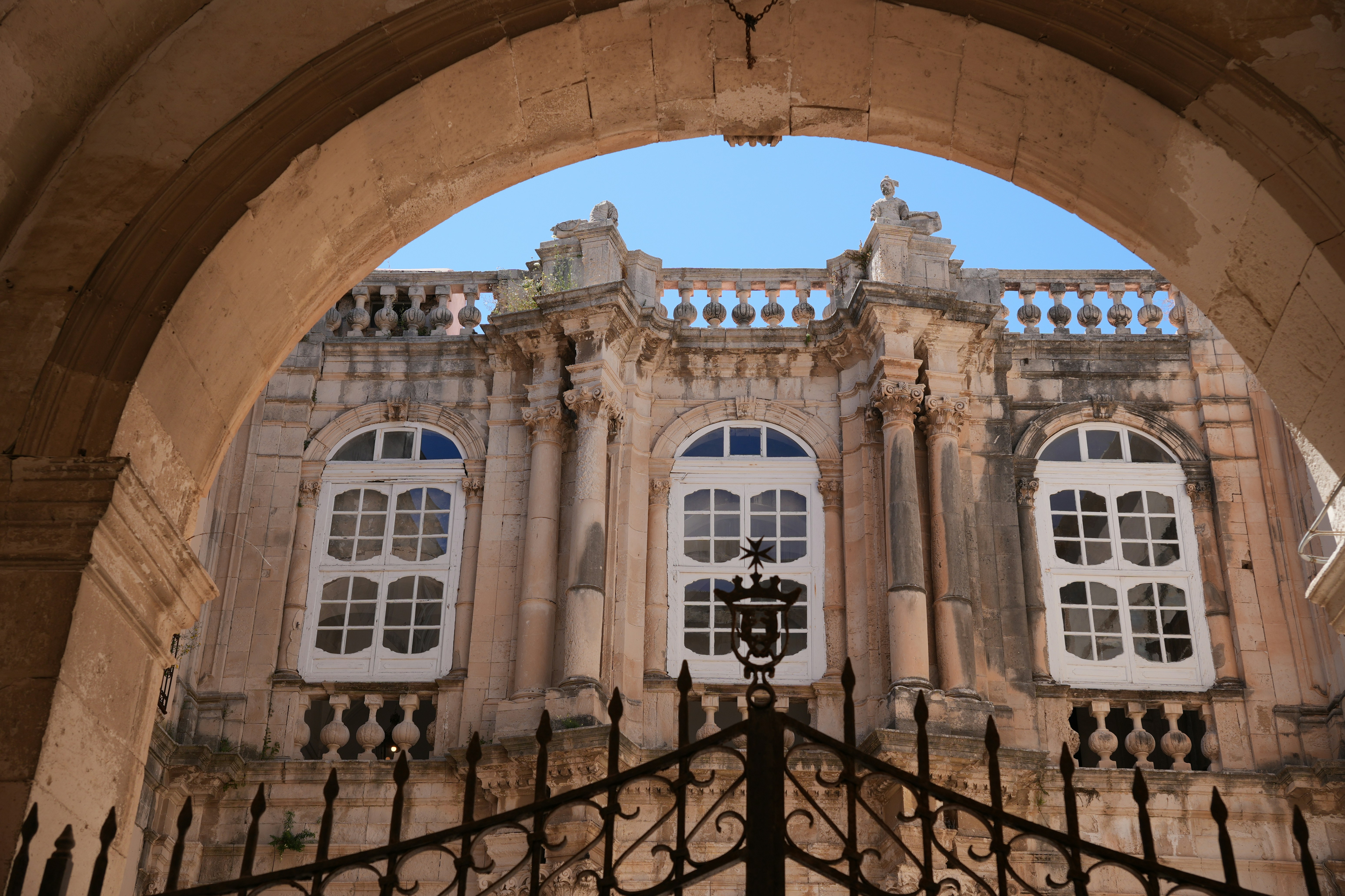 Old building with arched entrance and windows.