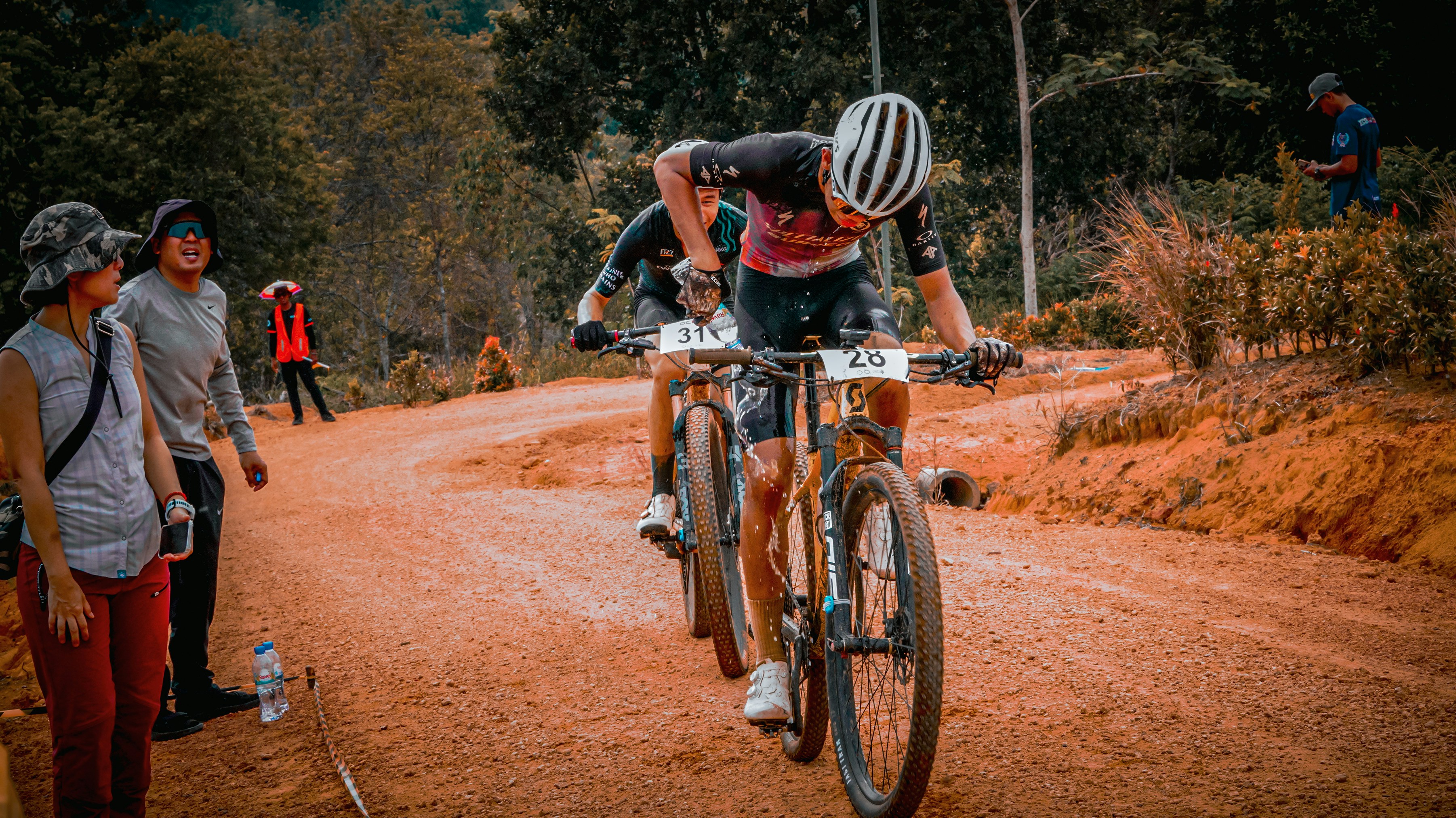 Mountain bikers compete on a dusty, off-road course.