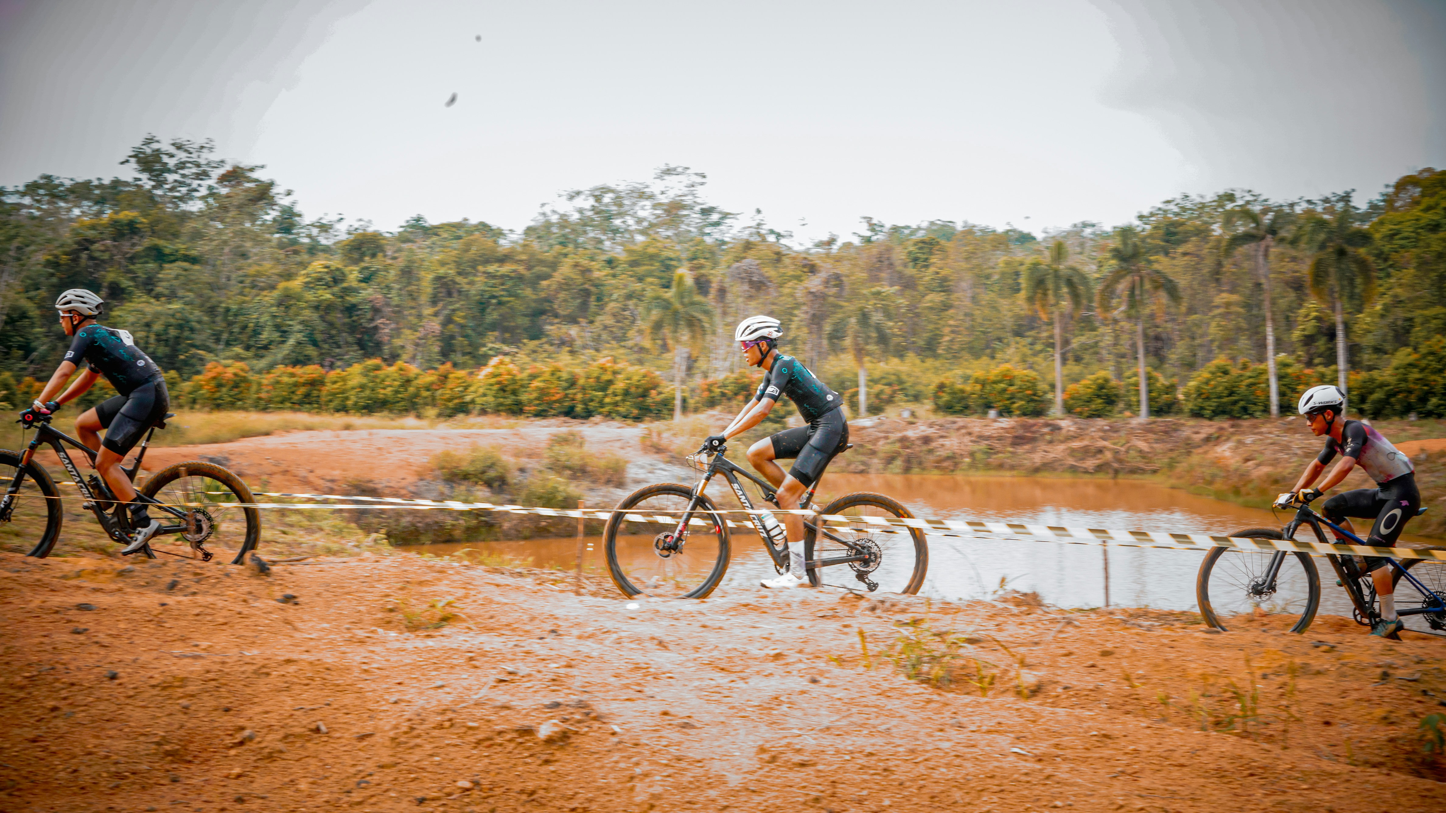Cyclists race on an off-road course.