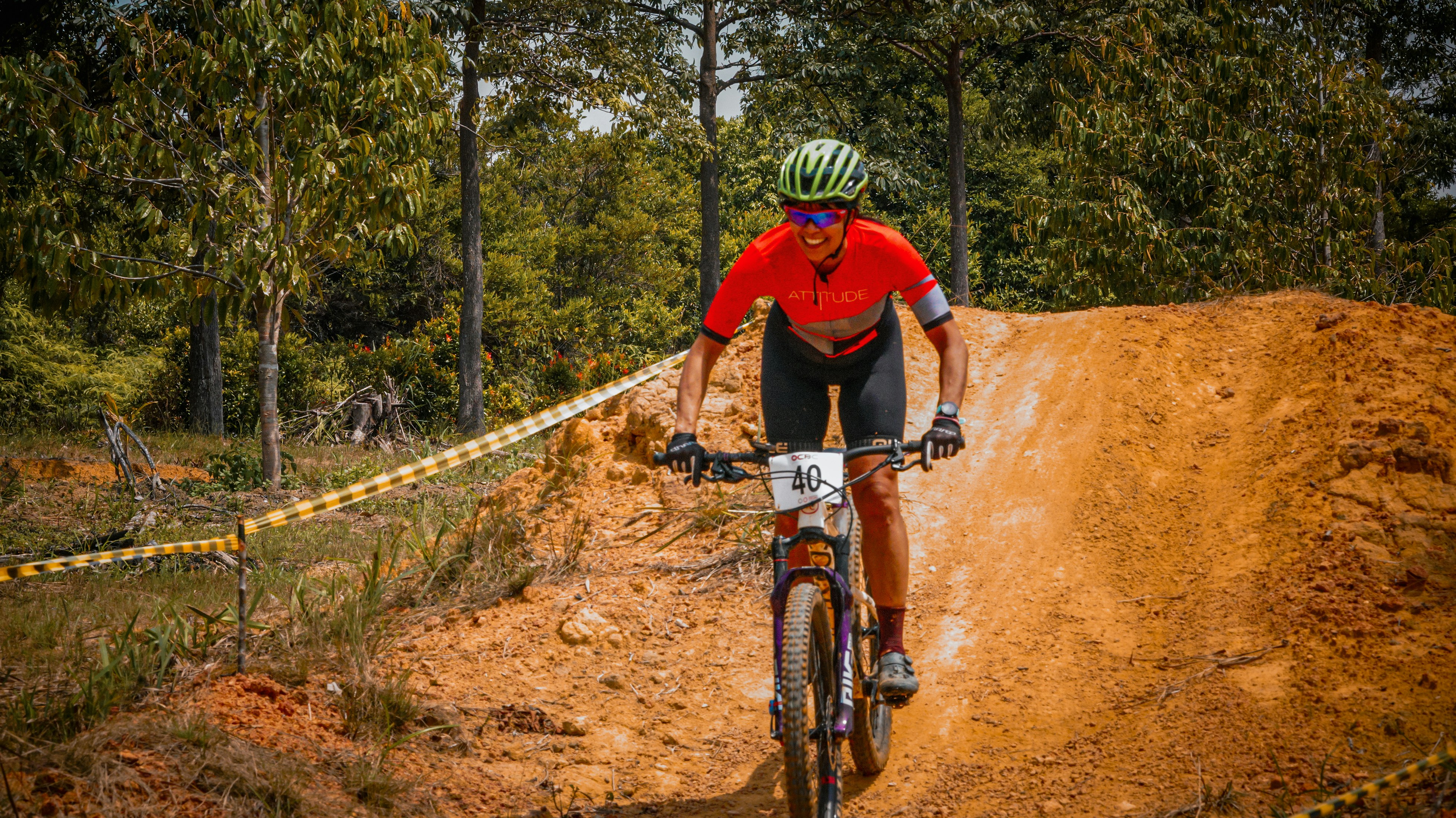 A cyclist races up a dirt hill.