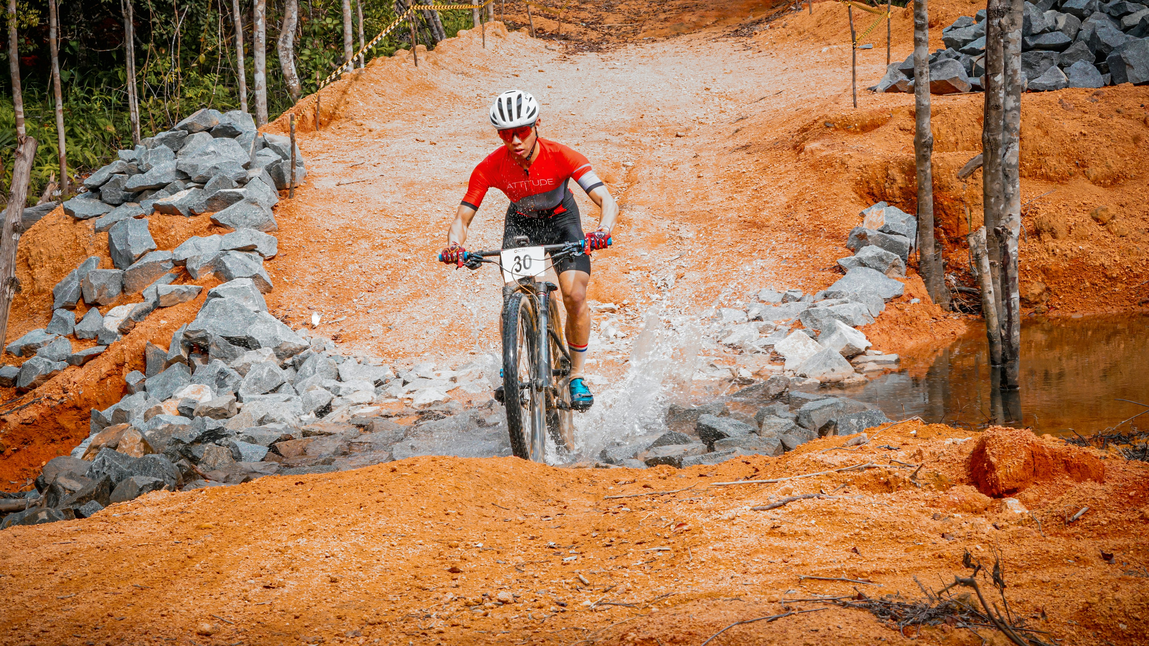 A mountain biker rides through the mud.