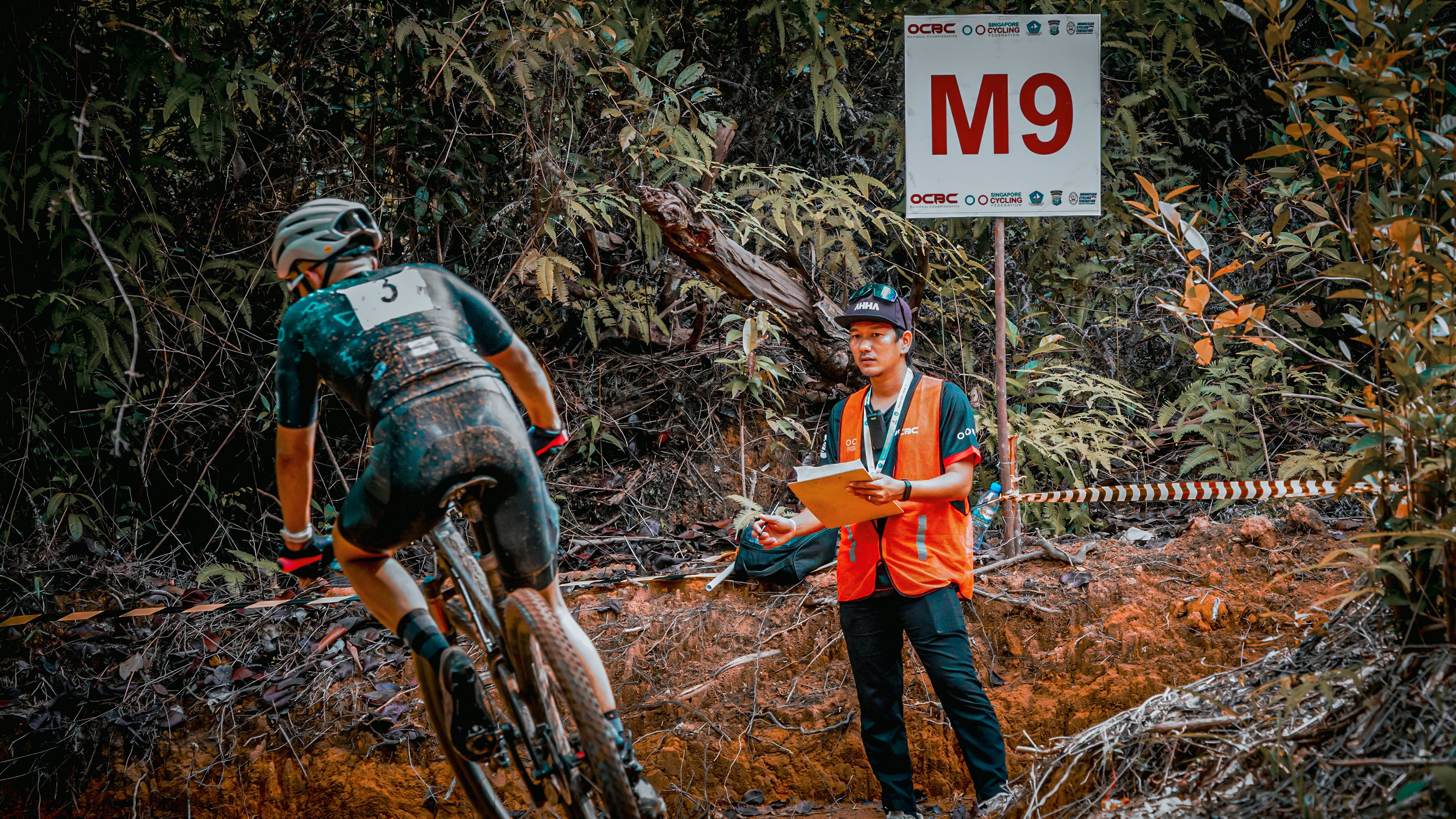 Cyclist rides past an official during a race.