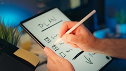 Someone is writing a plan on a tablet.