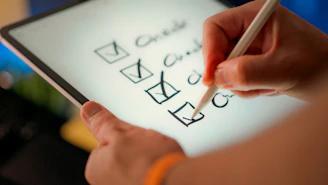 A hand marks off items on a checklist.