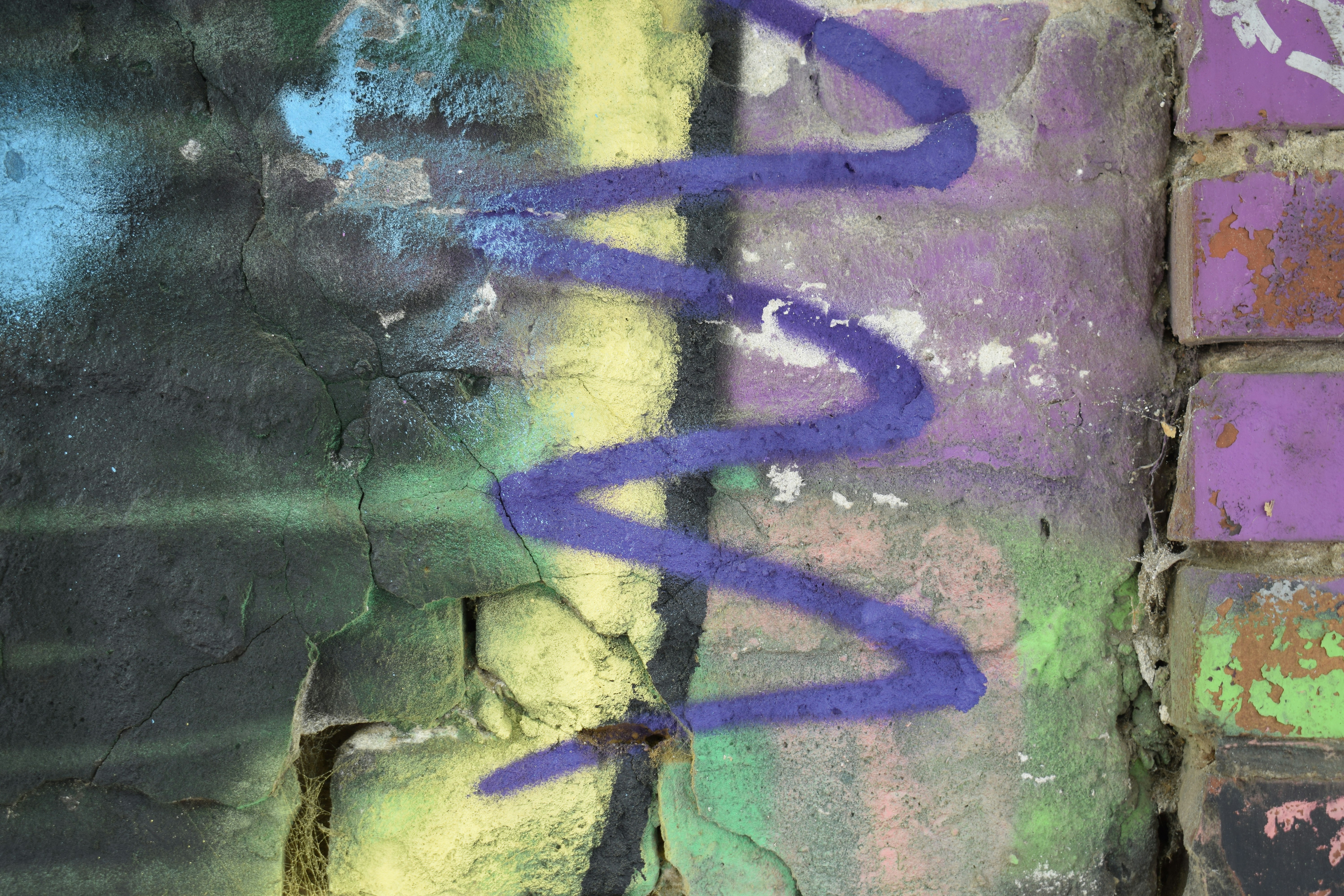 Graffiti art covers a weathered brick wall.