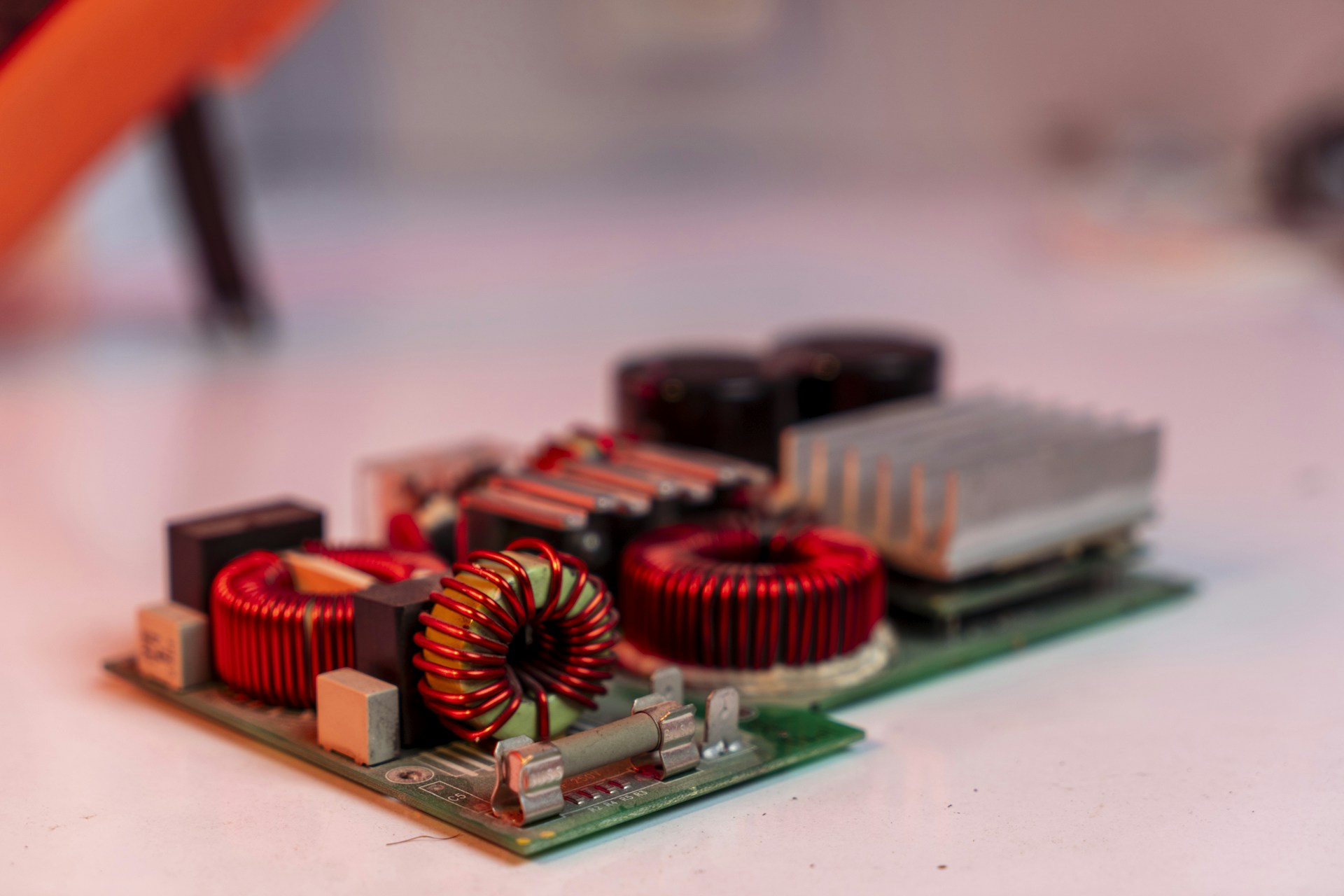 Circuit board with electronic components on white surface.