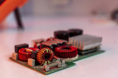 Circuit board with electronic components on white surface.
