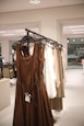 Brown dress and other clothing on hangers