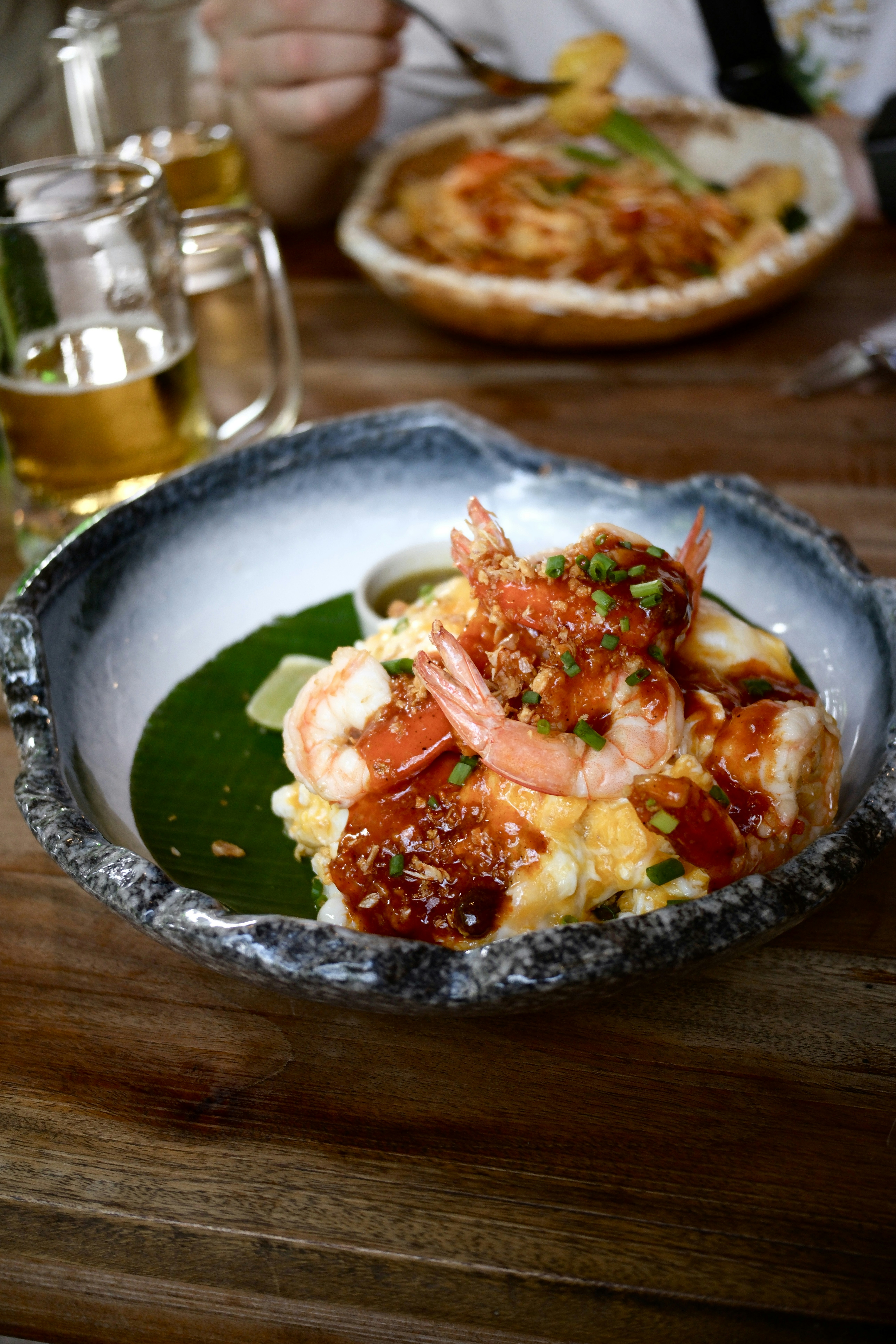 Shrimp and grits served in a decorative bowl.