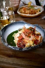 Shrimp and grits served in a decorative bowl.
