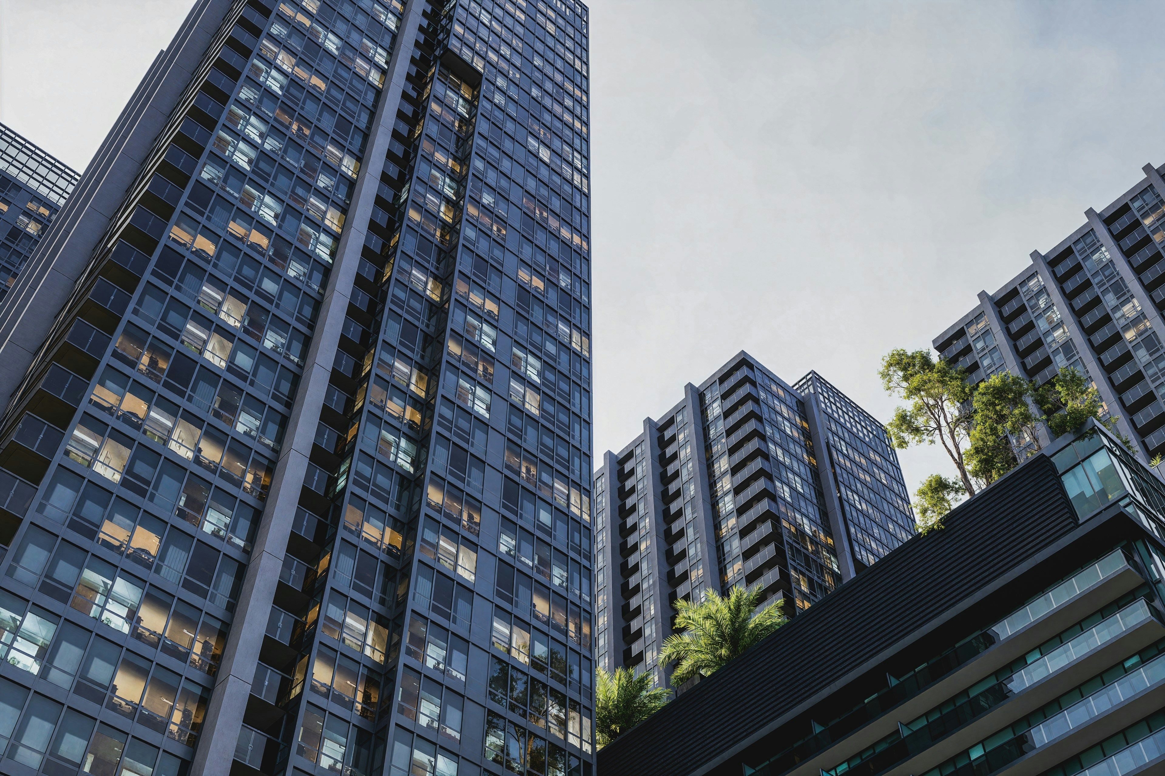 High-rise buildings stand tall against a cloudy sky.