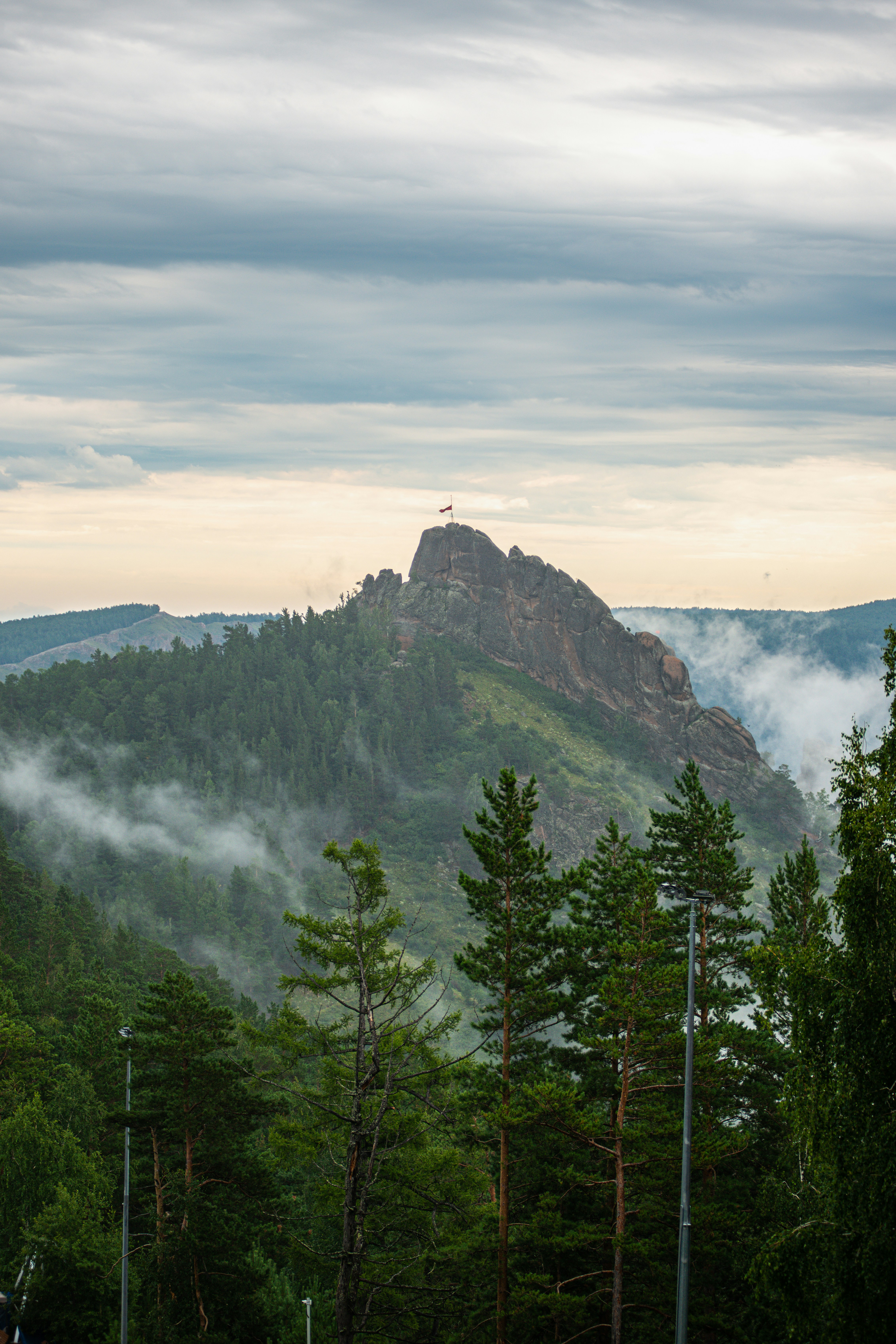 A mountain stands tall above lush greenery.