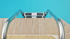 Pool steps lead into clear, blue water