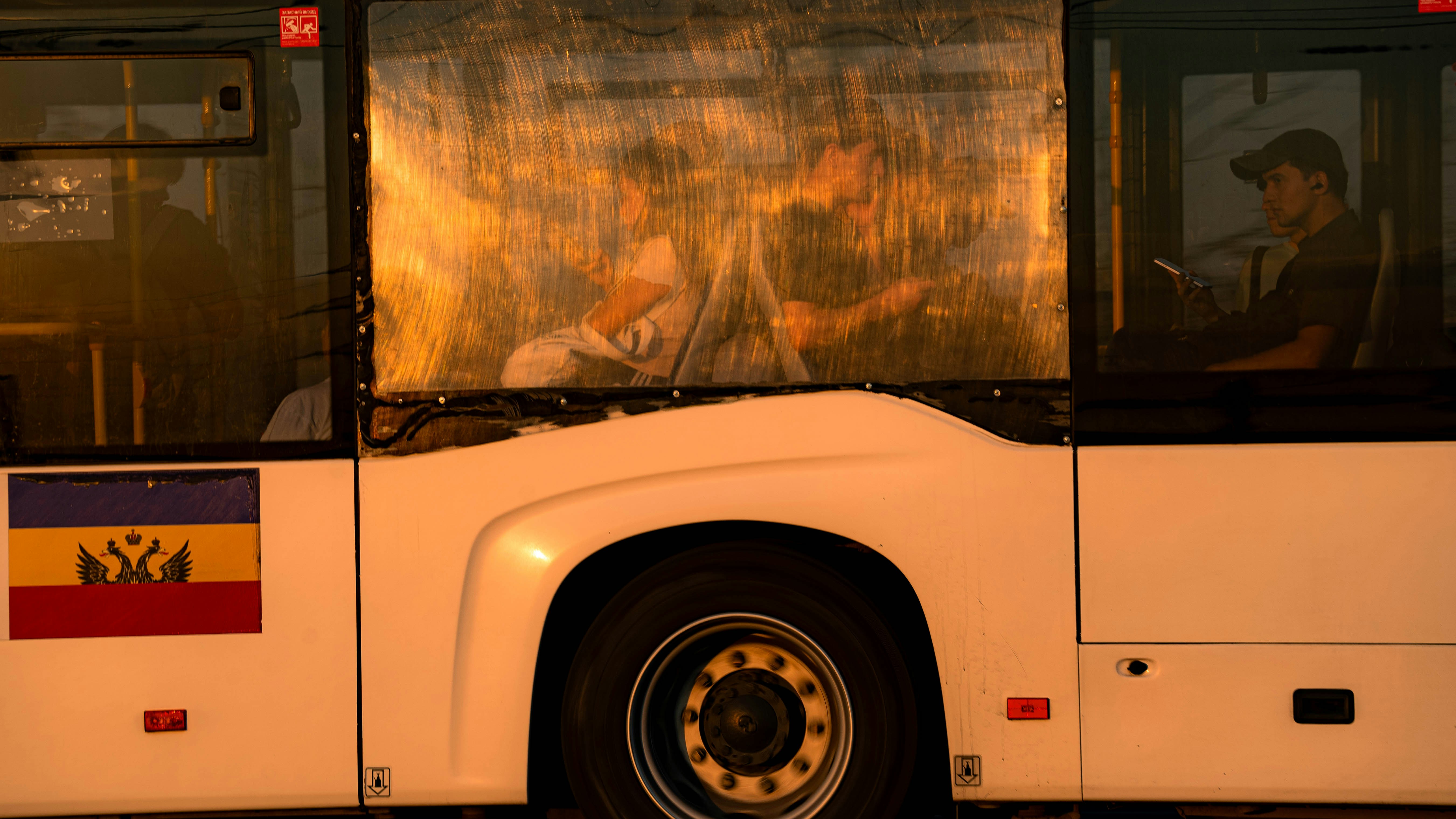 A bus, passengers, and moldovan flag.