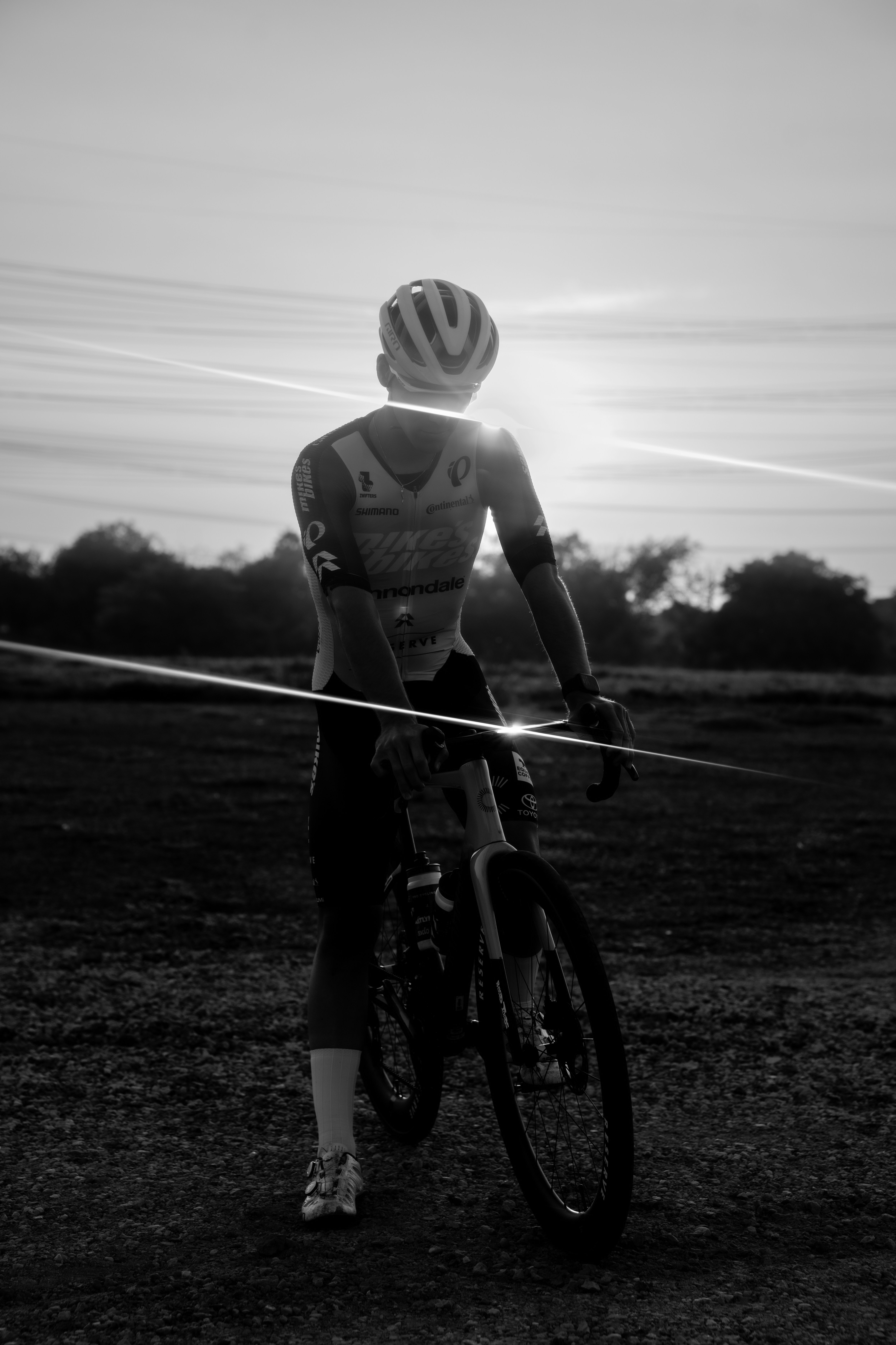 Cyclist watches the sunrise over the finish line.