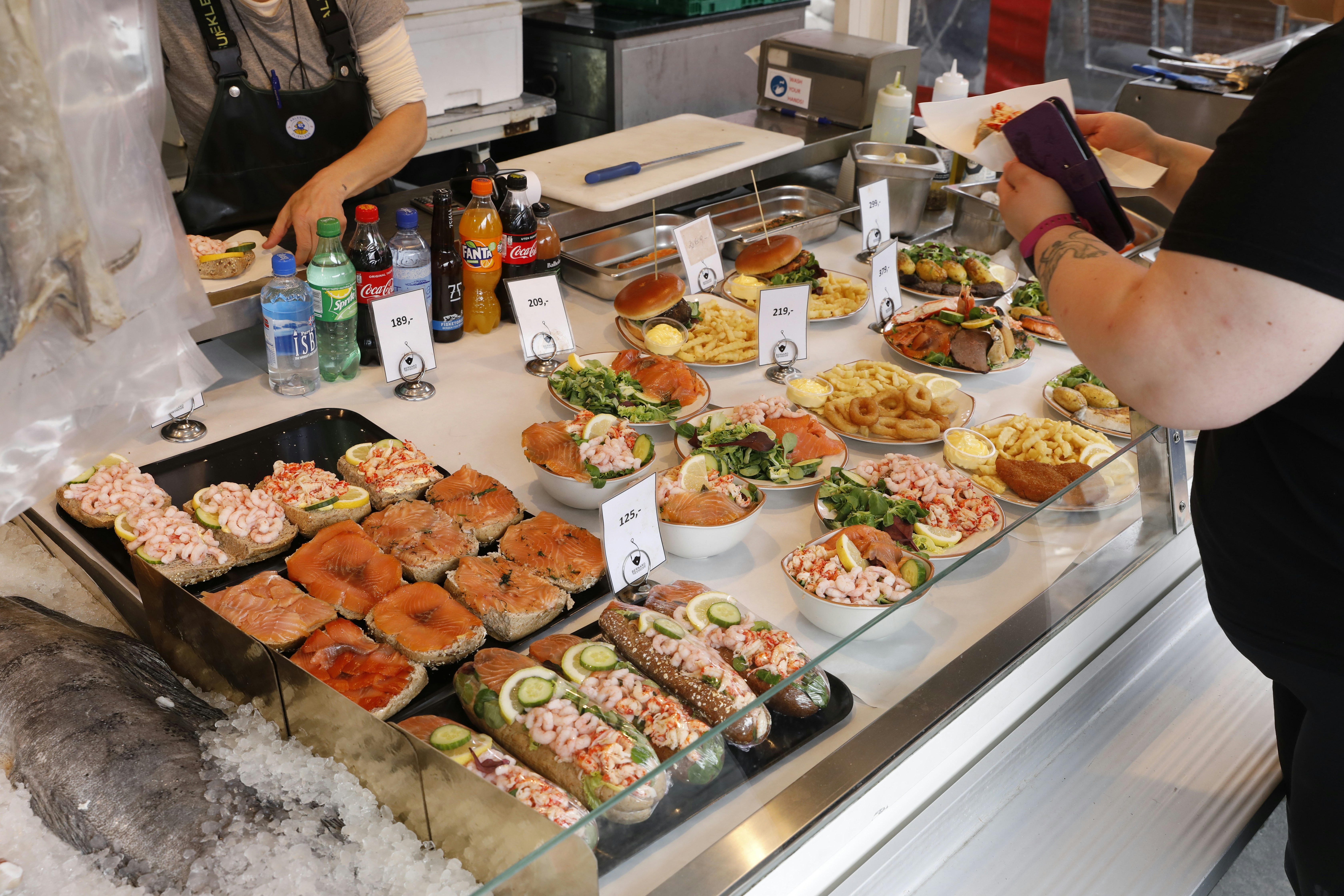A seafood display shows delicious food for purchase.