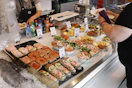 A seafood display shows delicious food for purchase.
