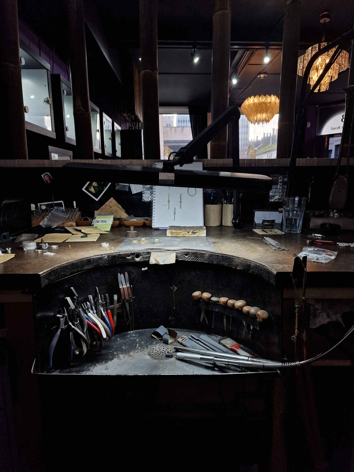 A goldsmith's workbench with files, pliers and a ring mandrel laid out
