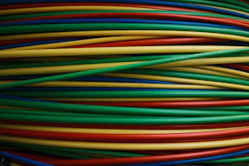 Colorful wires are bundled together, side by side.