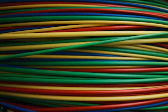 Colorful wires are bundled together, side by side.