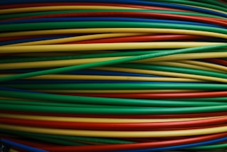 Colorful wires are bundled together, side by side.