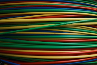 Colorful wires are bundled together, side by side.