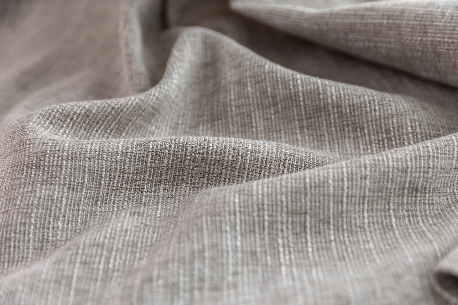 Grey cloth falling in soft folds, lit from one side