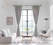 Modern living room with neutral color scheme and minimalist decor.