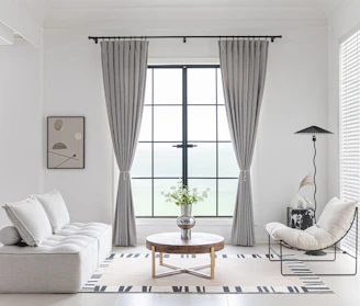 Modern living room with neutral color scheme and minimalist decor.