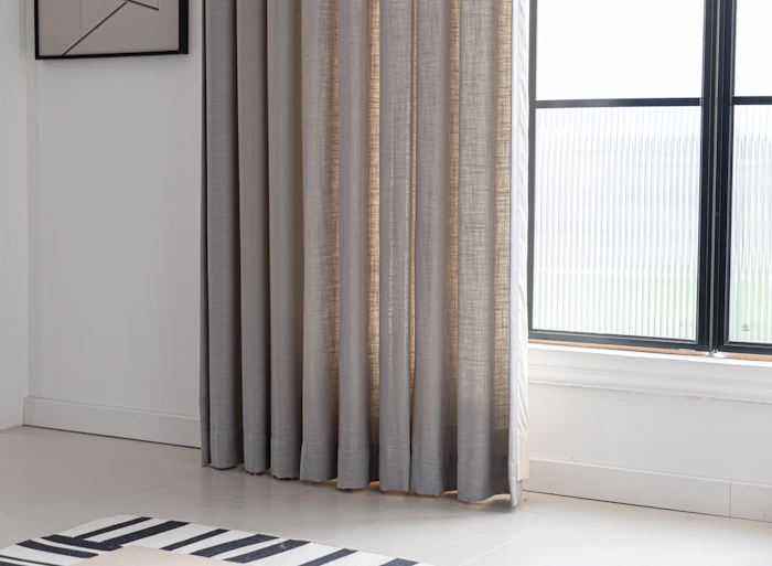 Floor-to-ceiling custom drapery elegantly framing a bright window